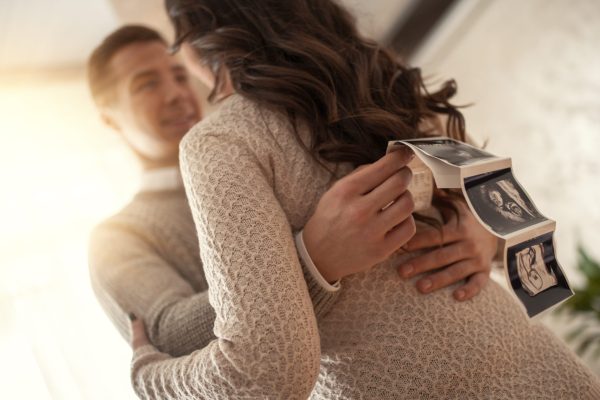 Beautiful young couple expecting baby Beautiful young couple expecting baby,they are holding ultrasound.